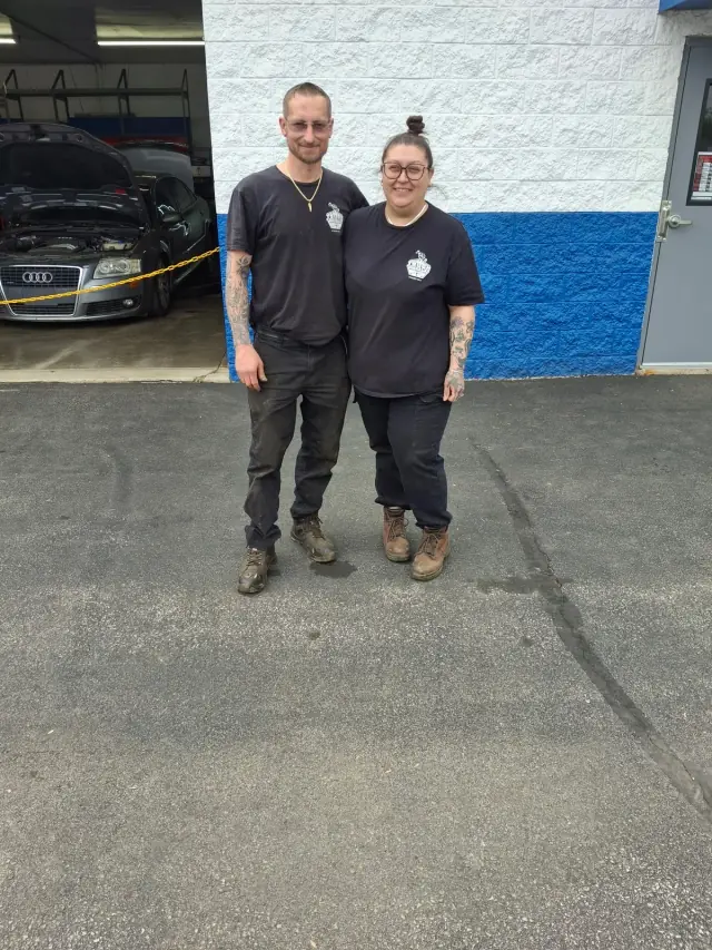 Cory and Ashley Adams, owners of Tough Knuckles Automotive, standing outside their shop in Holland, Ohio